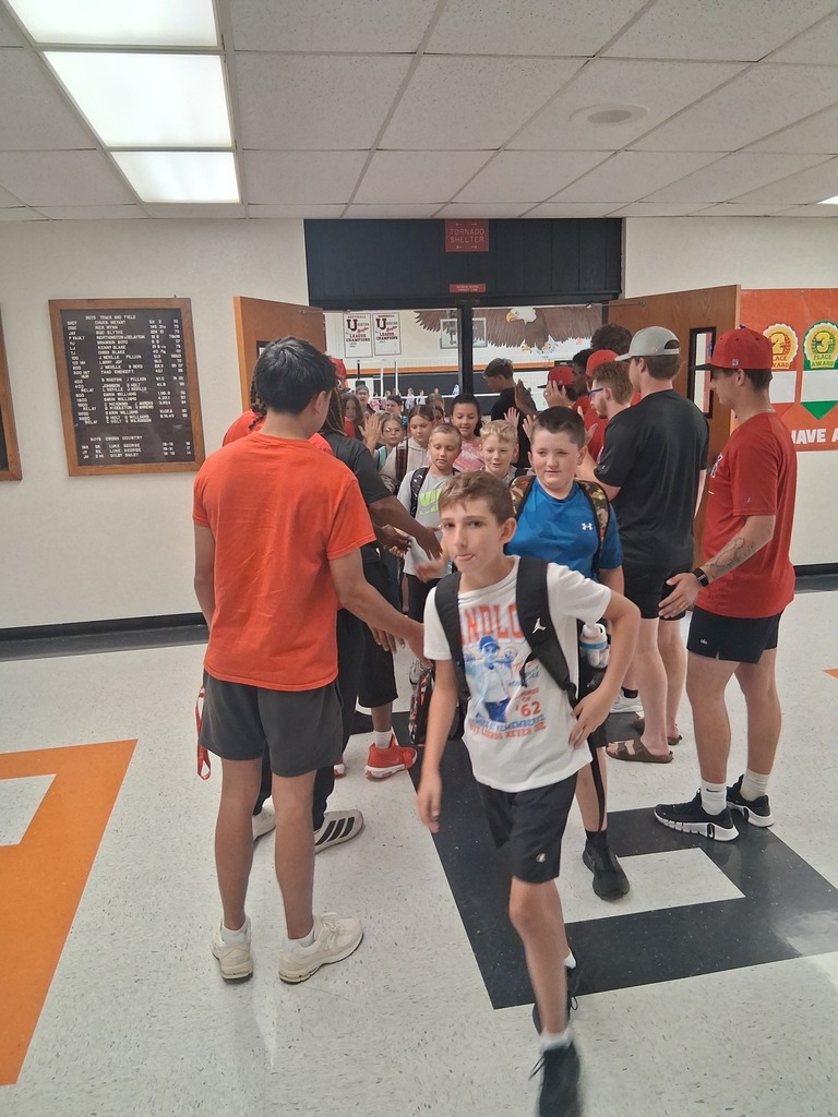 ACC athletes giving high 5's as WBE students head to class.