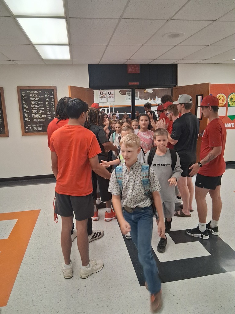 ACC athletes giving high 5's as WBE students head to class.