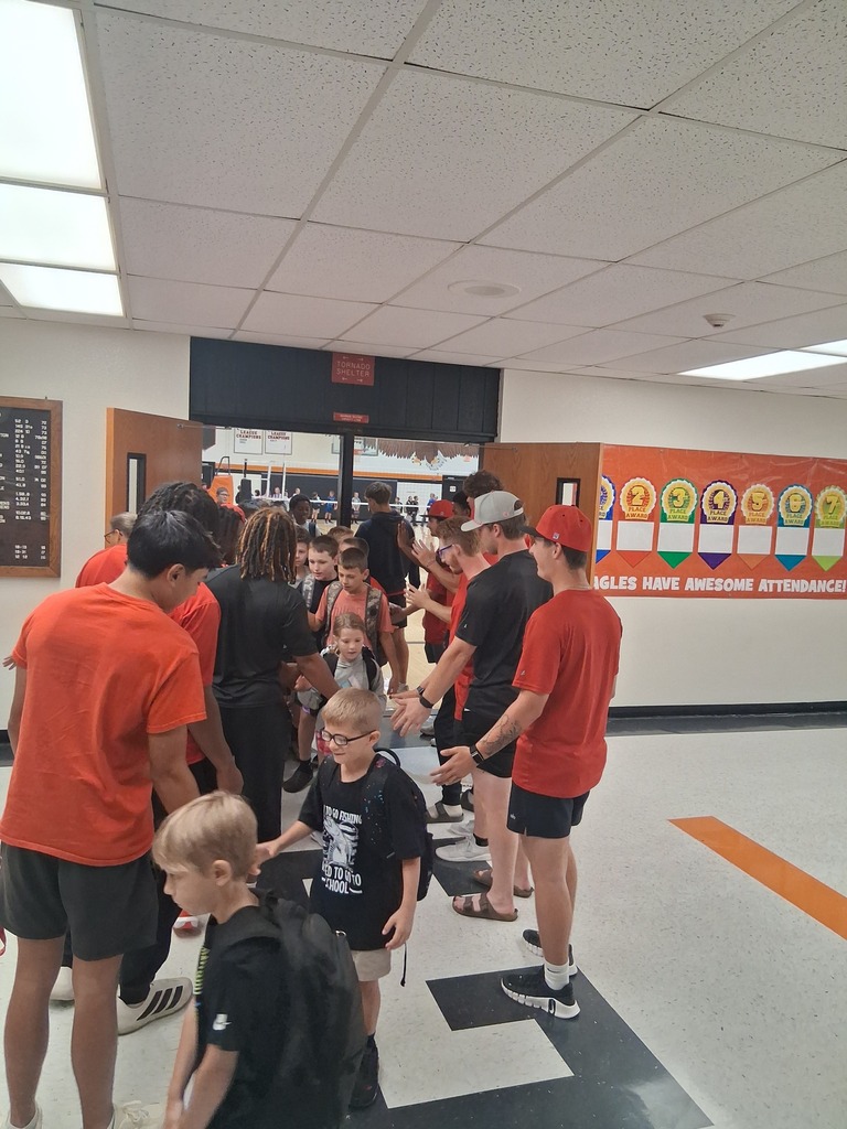 ACC athletes giving high 5's as WBE students head to class.