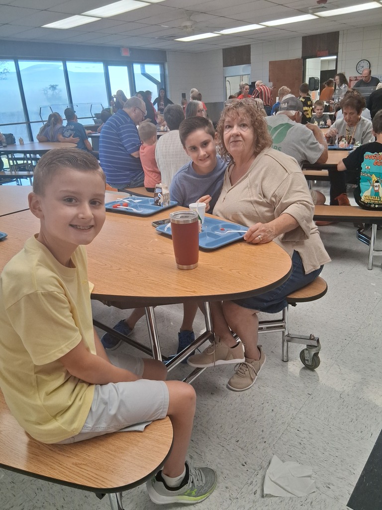 Grandma eating with her grandsons