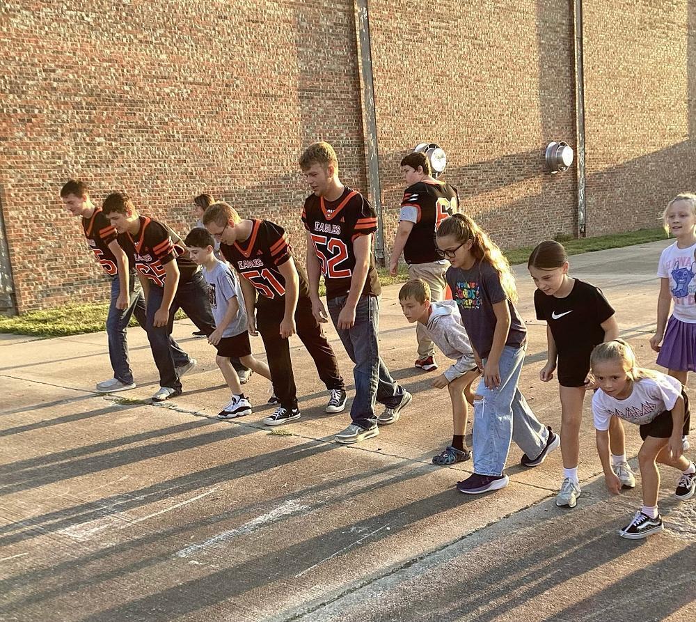 UHS football boys lined up for a race against WBE students