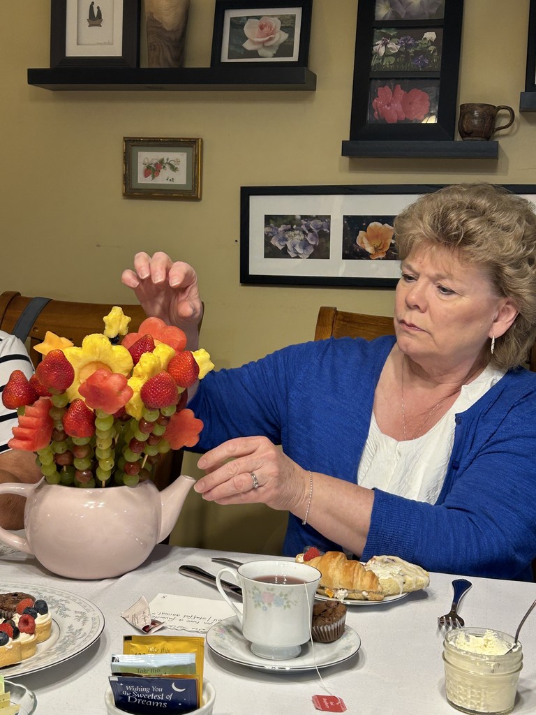 woman choosing a fruit kabob