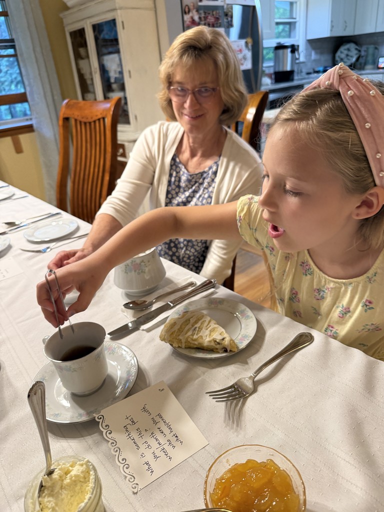 girl and her grandma putting sugar into tea