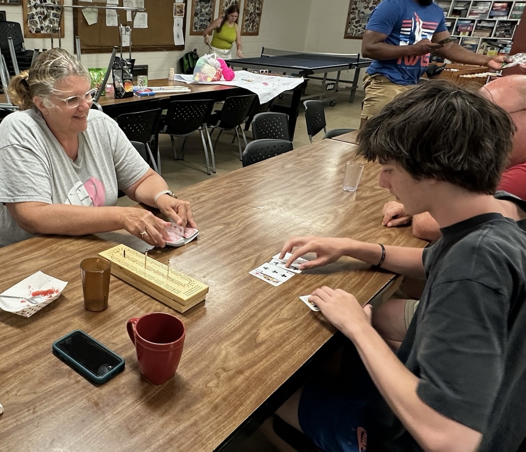 UCA math teacher playing cribbage with a former student at a summer bible camp