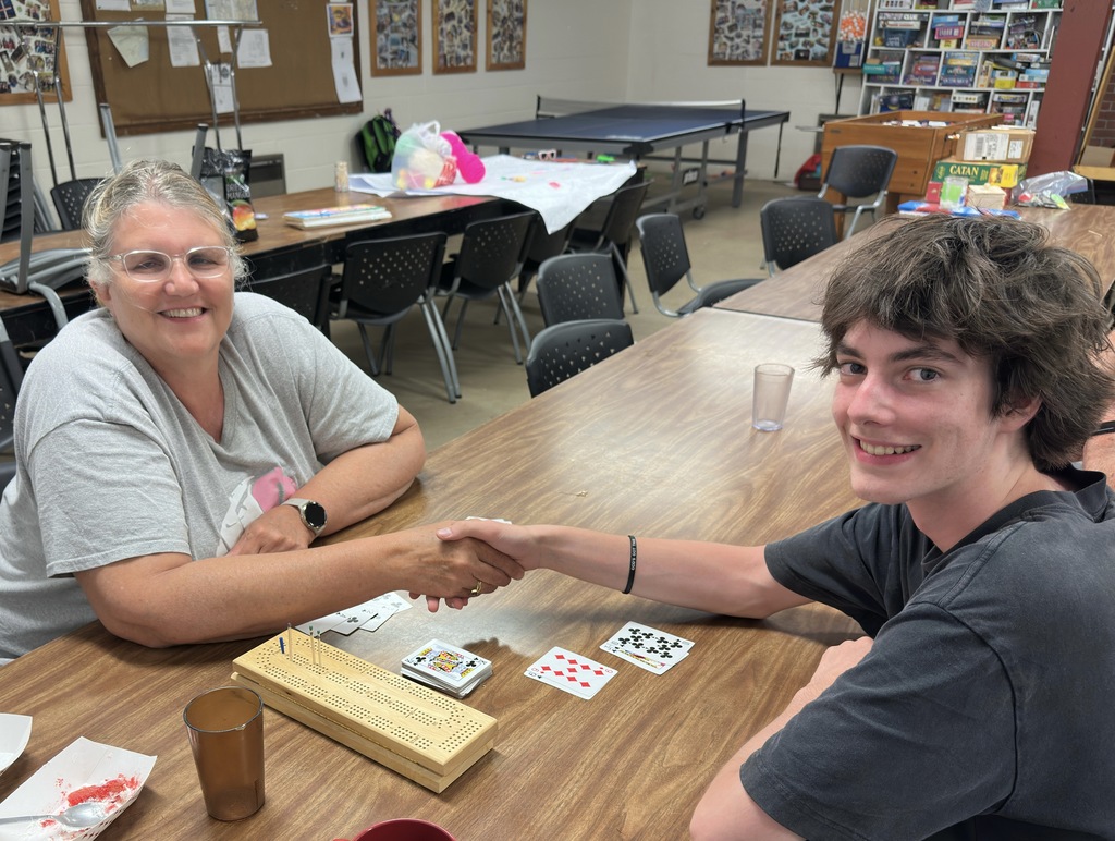 UCA math teacher playing cribbage with a former student at a summer bible camp