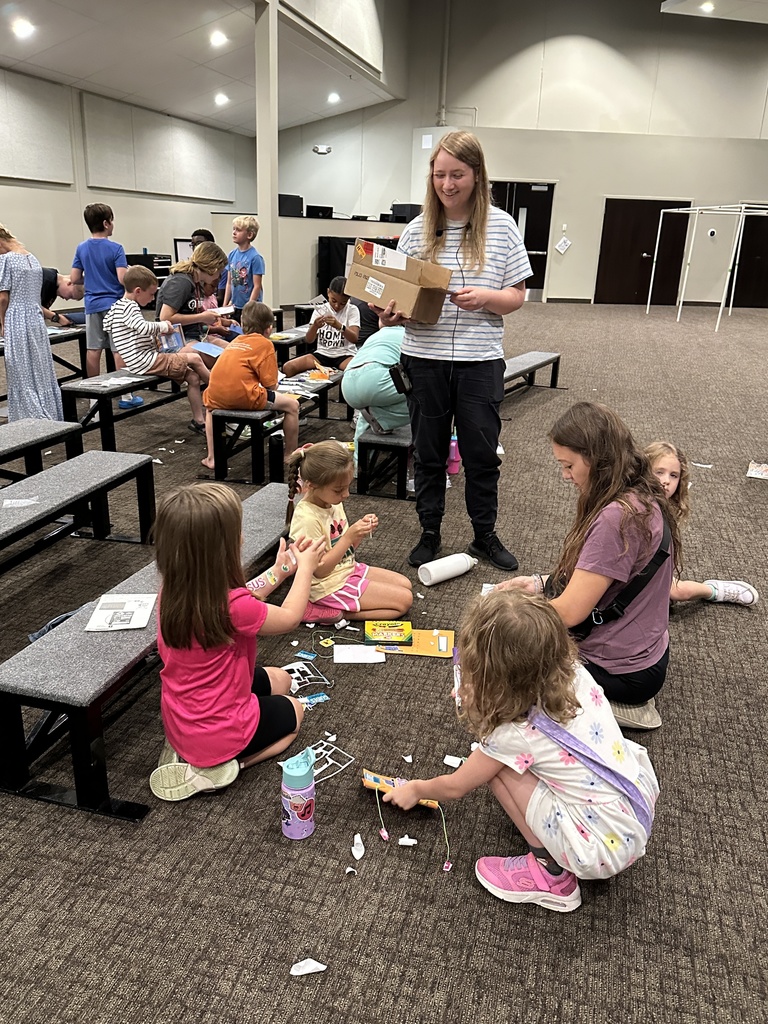 pastor passing out craft supplies to campers
