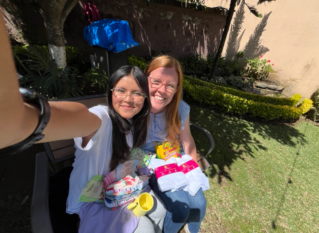 UCA teacher in Guatemala pictured with a child our school sponsors