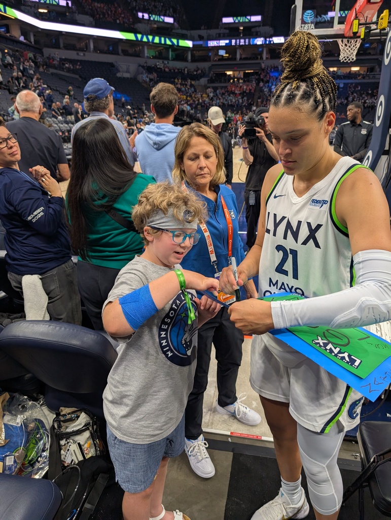 UCA student getting an autograph from a MN Lynx player