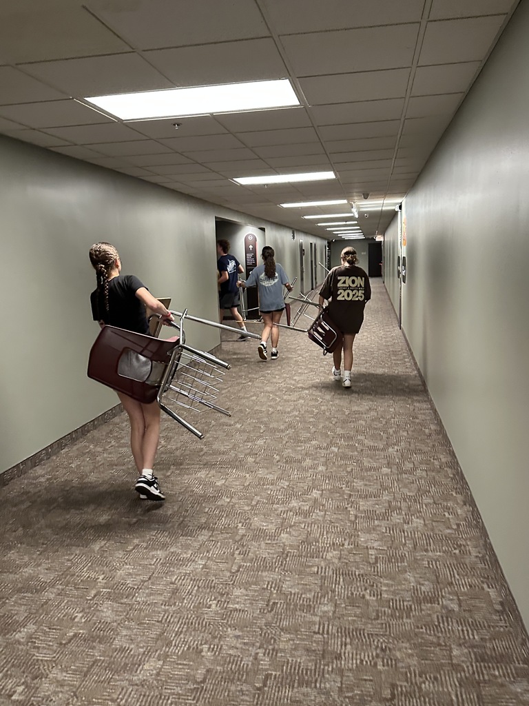 students moving furniture