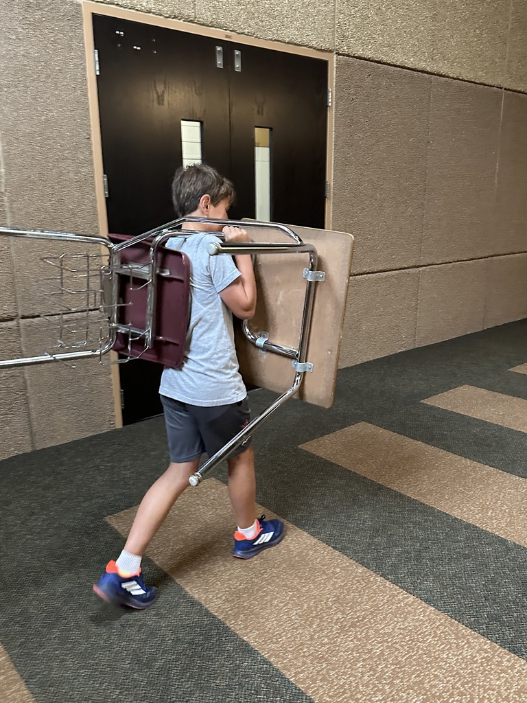 students moving furniture