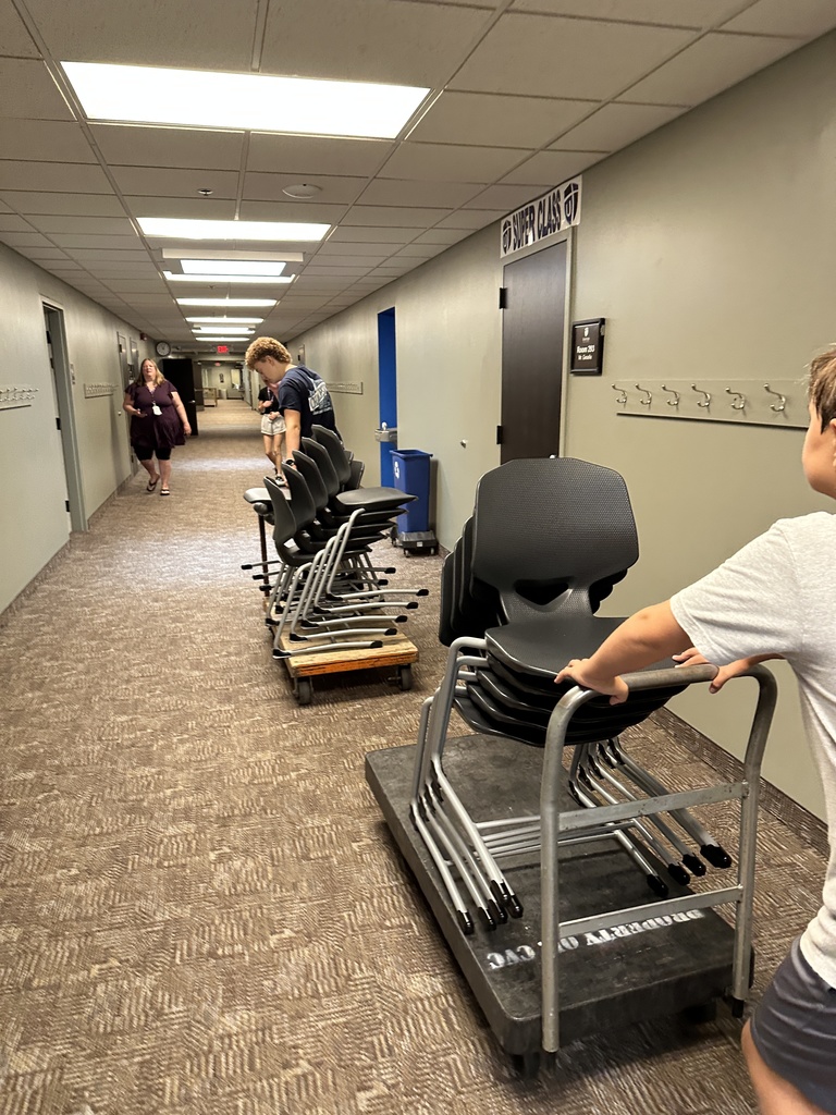students moving furniture