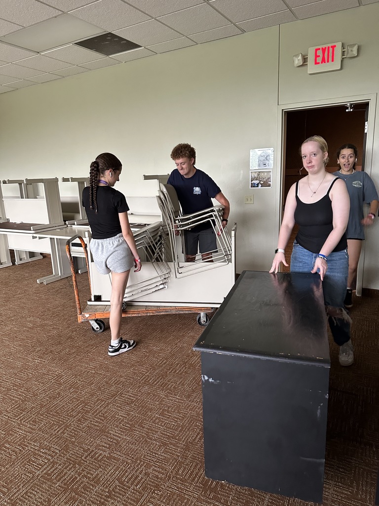 students moving furniture
