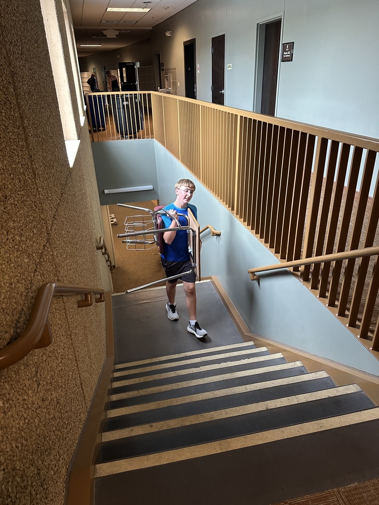 students moving furniture