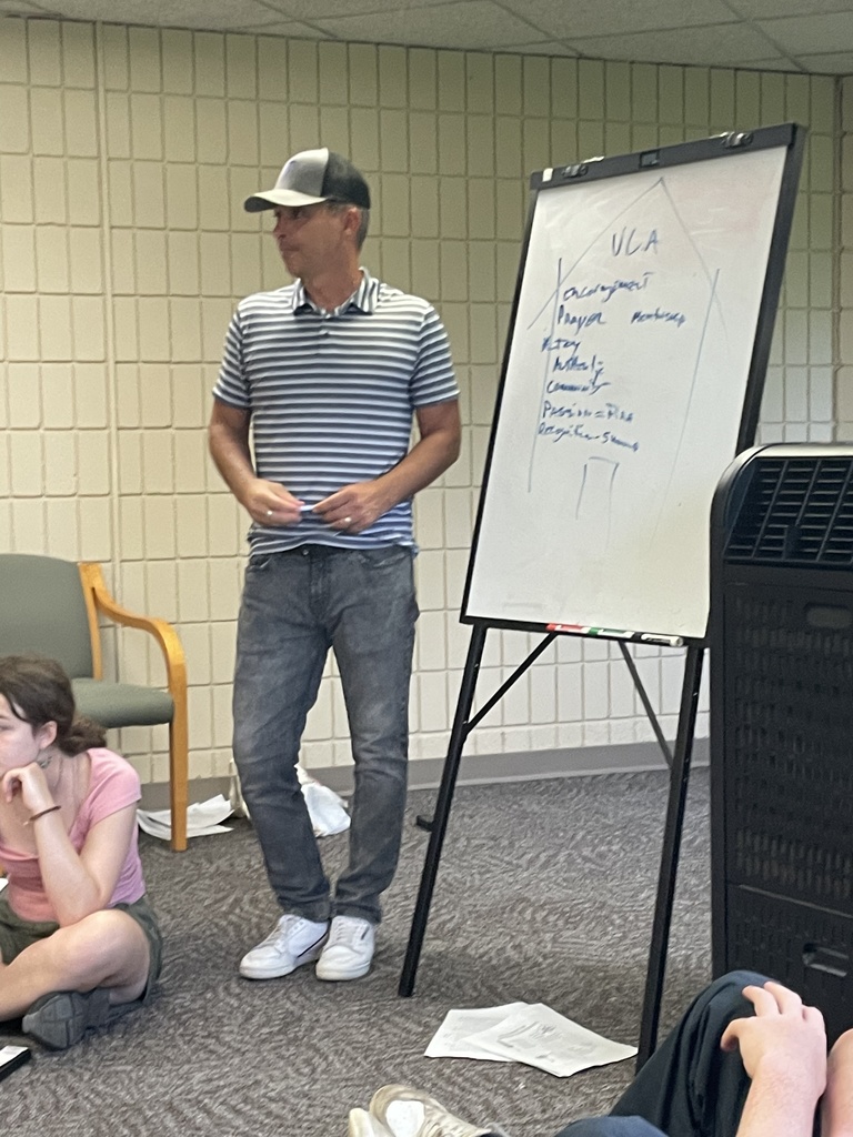 head of school standing at a whiteboard