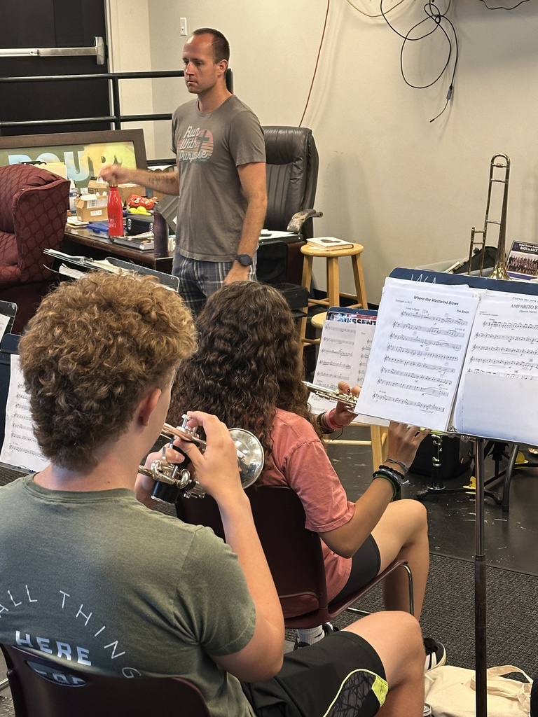band students practicing with their director