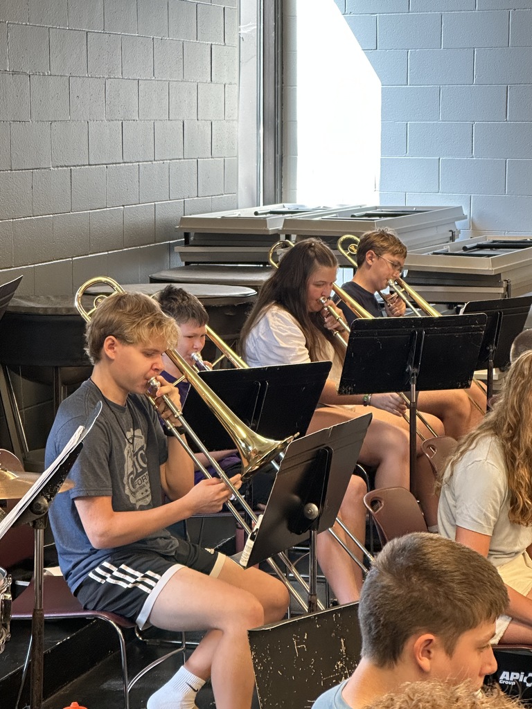 four trombone students practicing