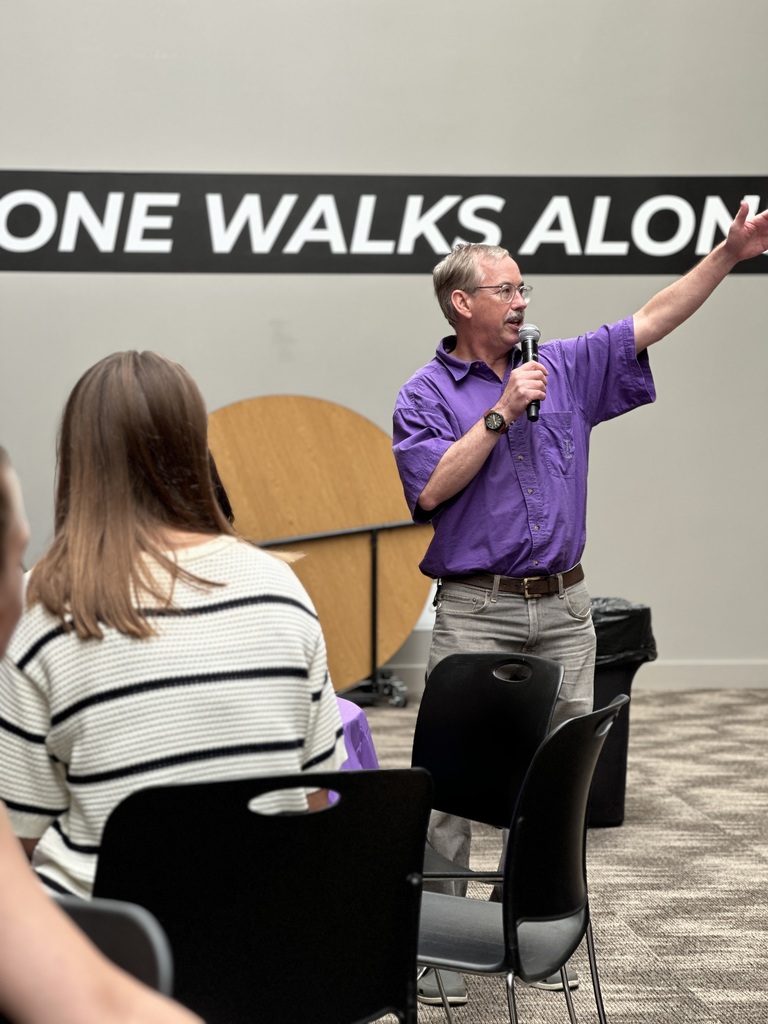 principal speaking to a group of teachers and church staff