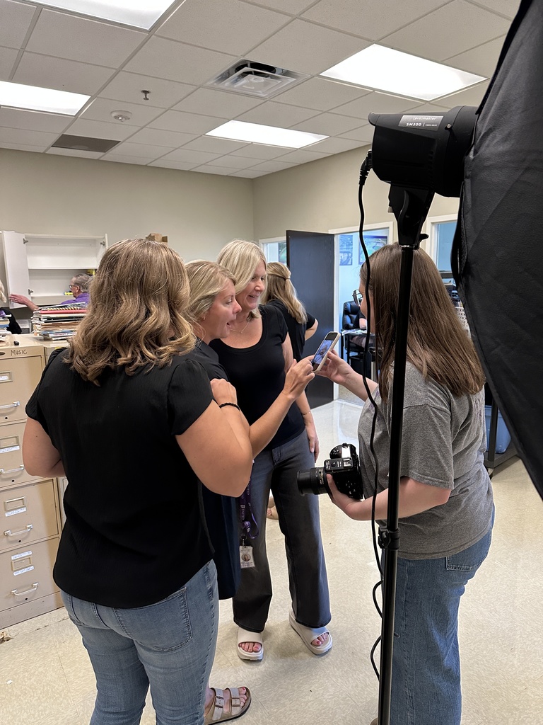 staff members looking at pictures