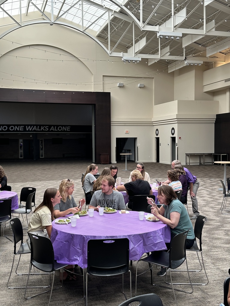 staff seated at tables eating lunch