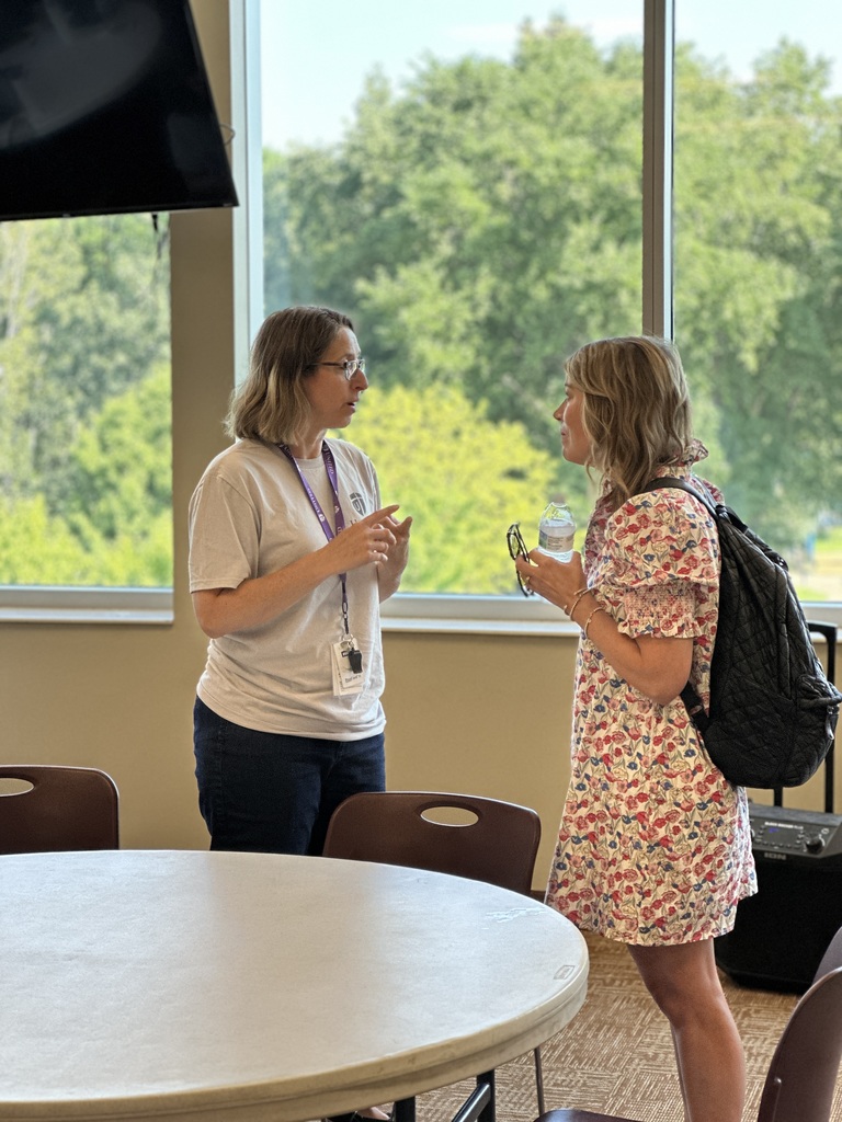 a teacher having a discussion with the presenter
