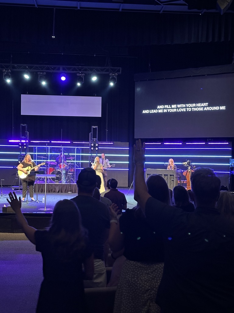 staff on stage leading a worship song