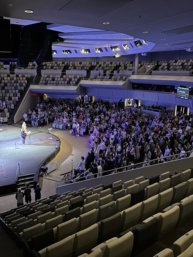 auditorium full of families singing a worship song