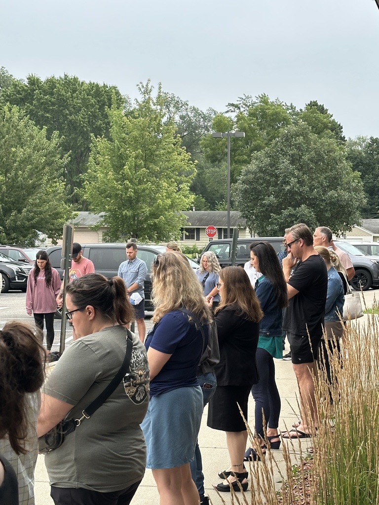 parents standing in a circle praying