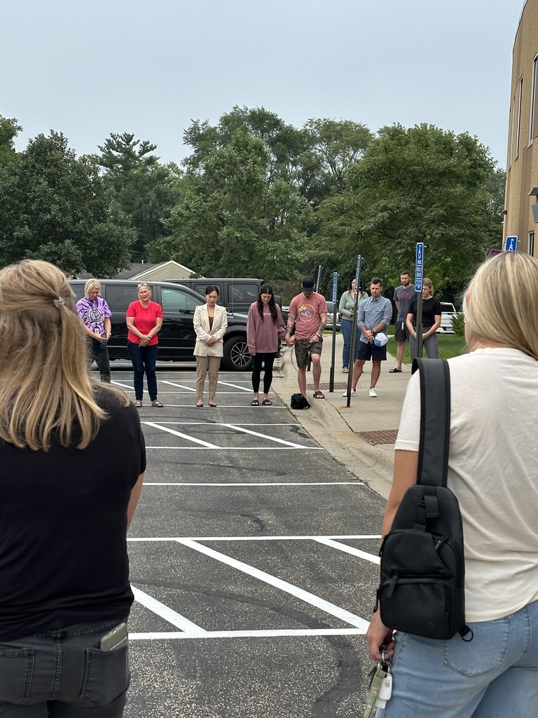 parents standing in a circle praying