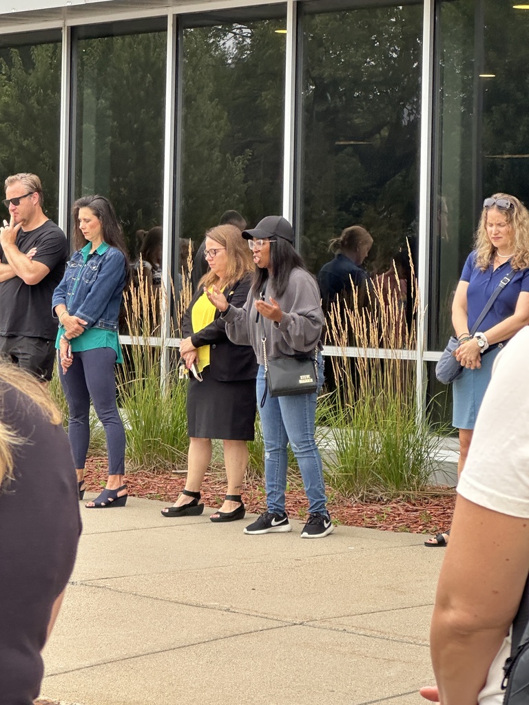 parents standing in a circle praying
