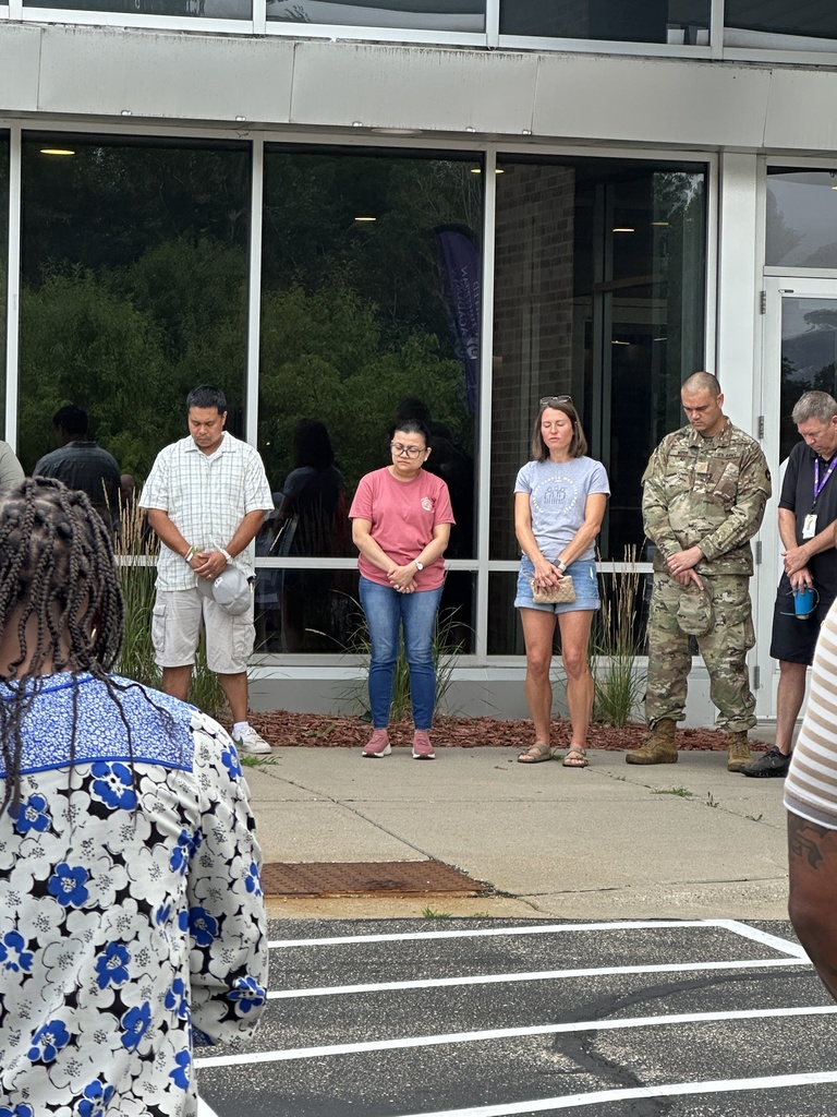 parents standing in a circle praying