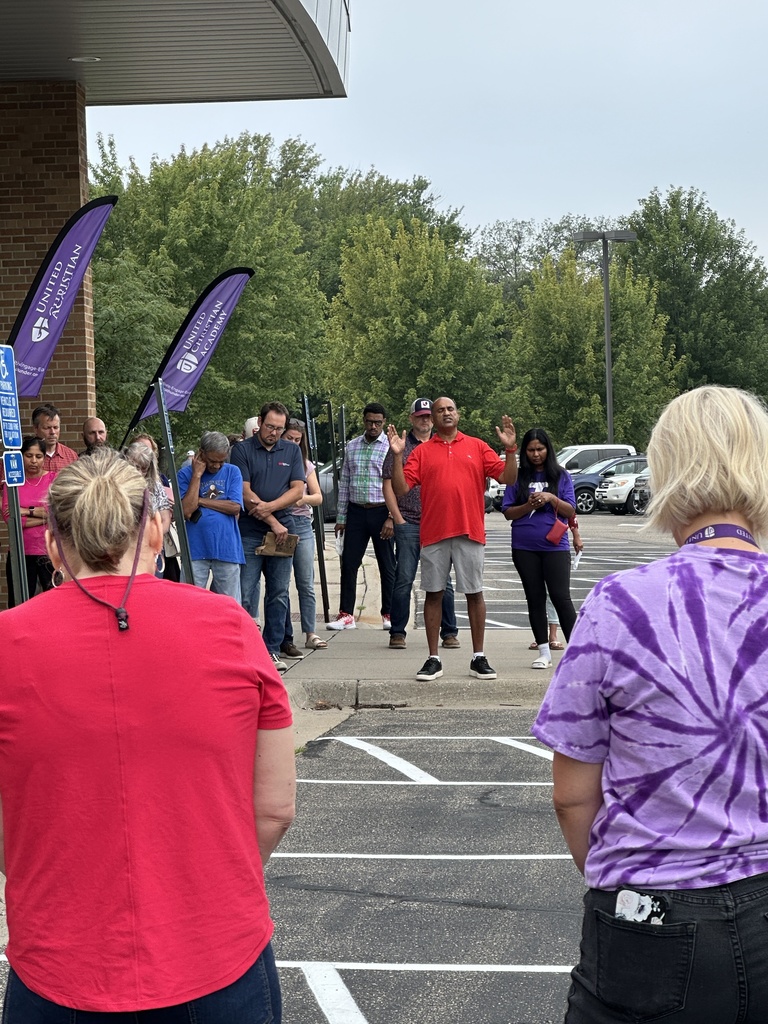 parents standing in a circle praying