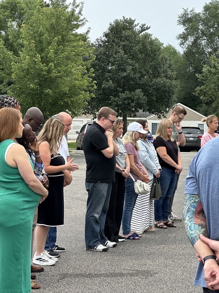 parents standing in a circle praying