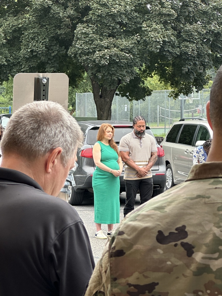 parents standing in a circle praying
