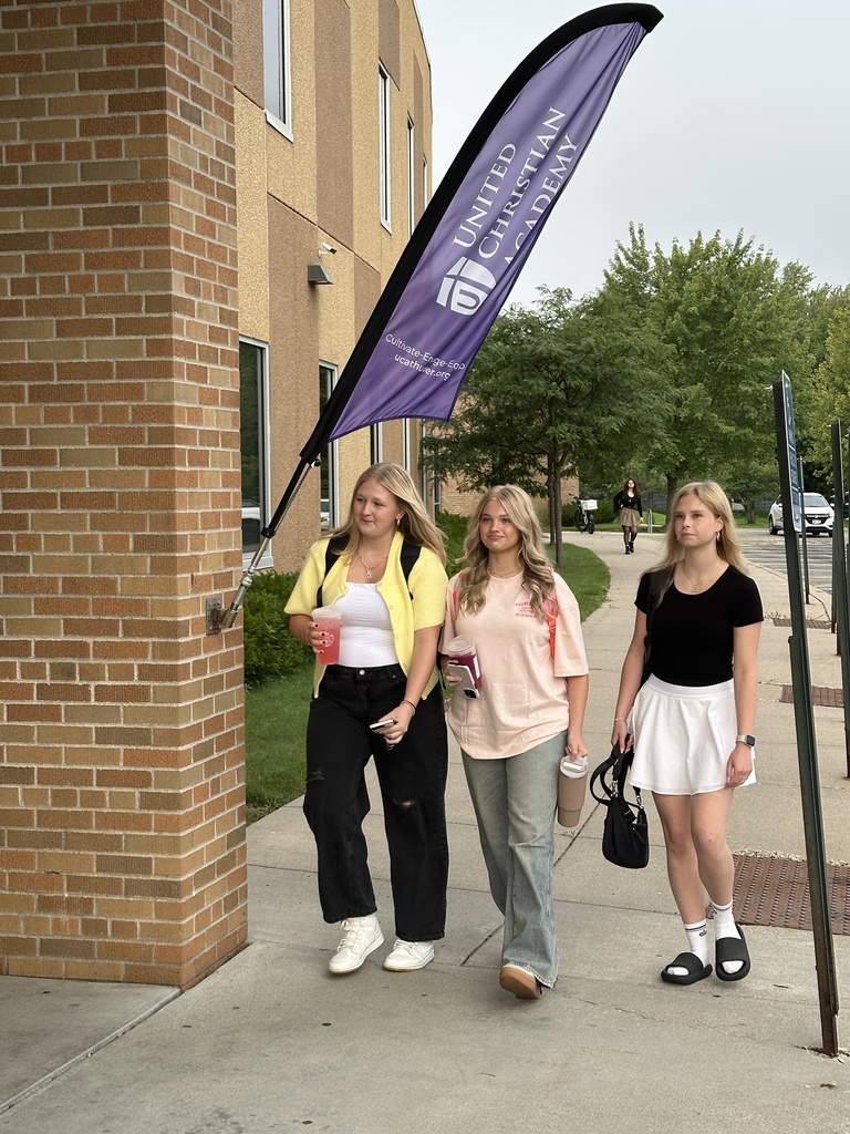 high school students walking into the building