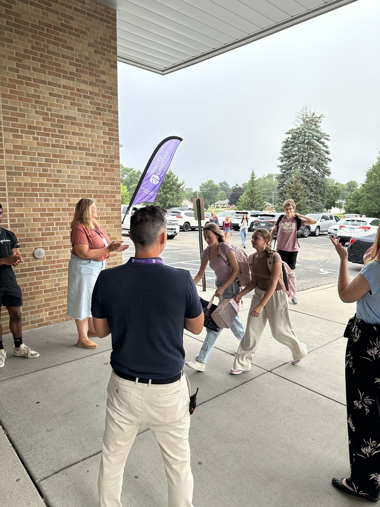 high school students walking into the building