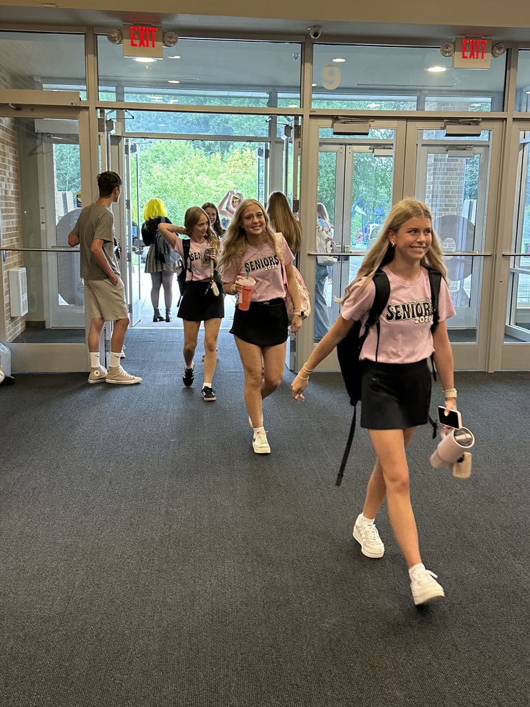 high school students walking into the building