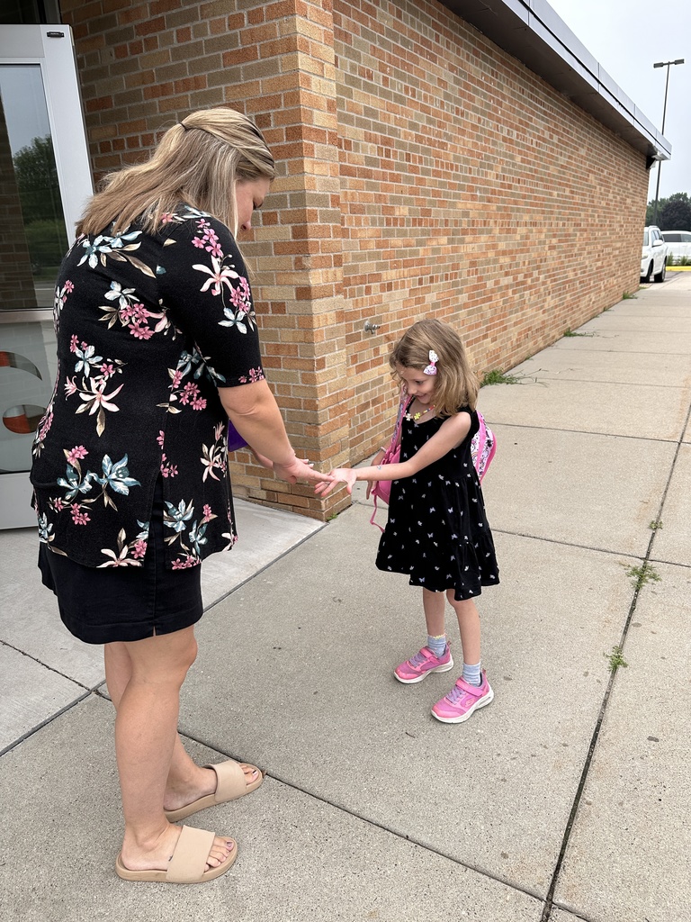 teacher greeting a student on the first day of school