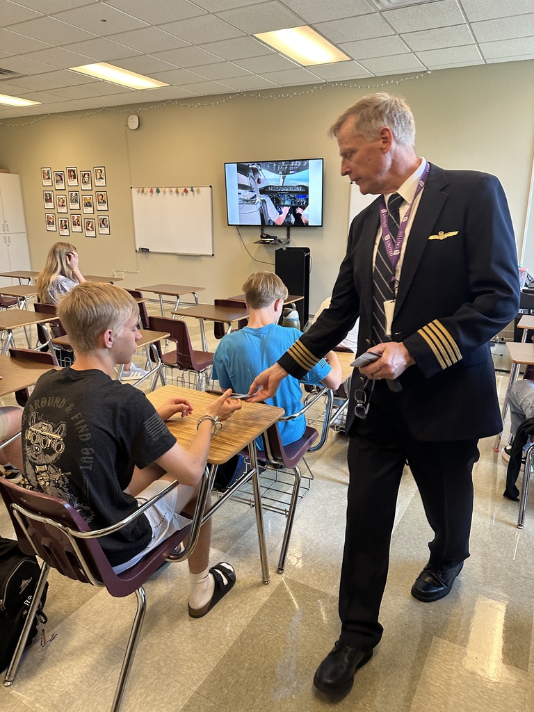 aviation teacher handing out airplane cards