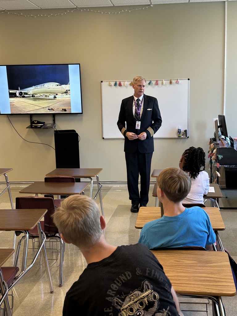 aviation teacher standing at the front of a classroom talking to students