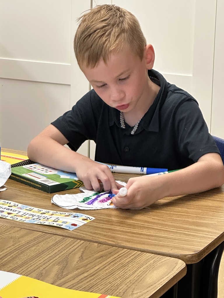 students sitting at their desks coloring