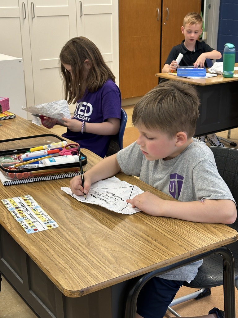 students sitting at their desks coloring