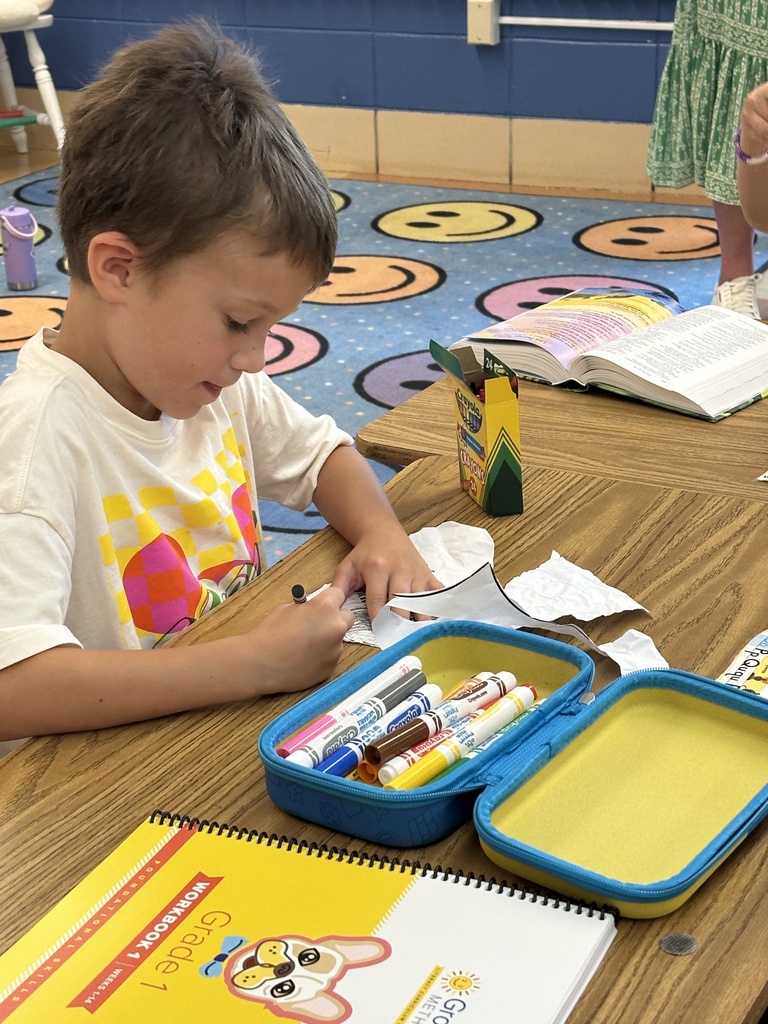 students sitting at their desks coloring
