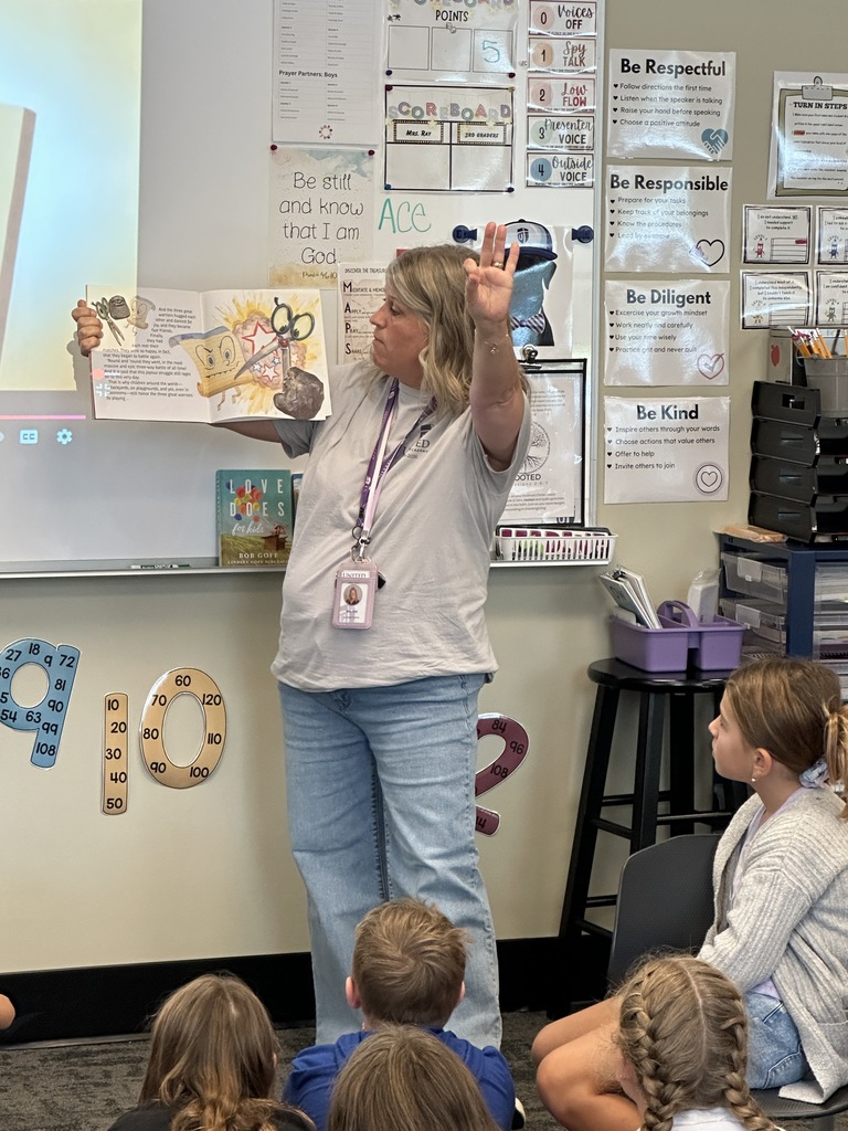 teacher reading a story in front of the class