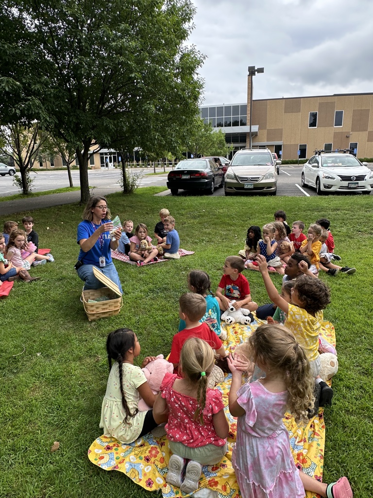 students sitting on blankets having a "teddy bear" picnic