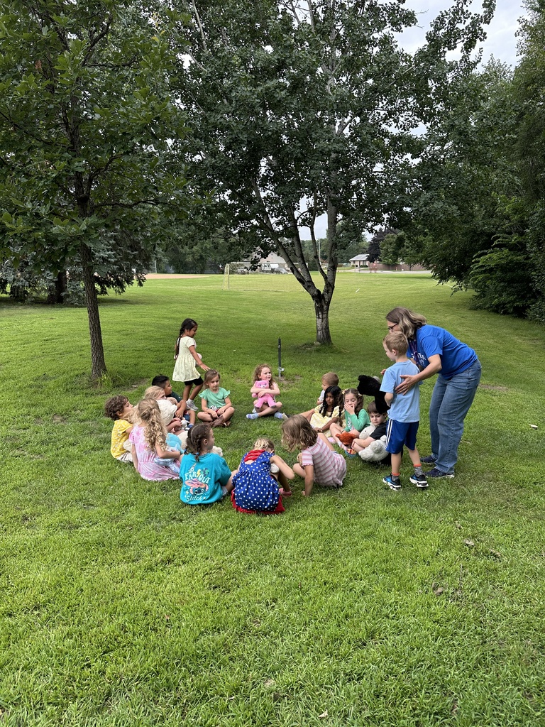 kindergarten students playing duck, duck, goose