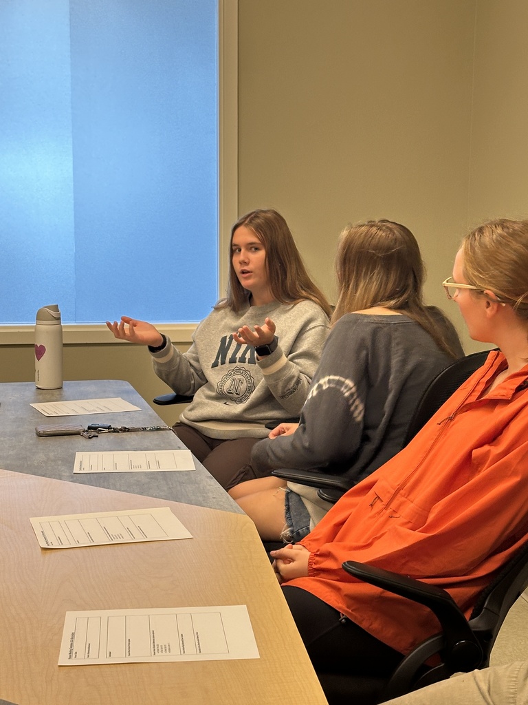 group of senior leaders sitting at a table for a meeting