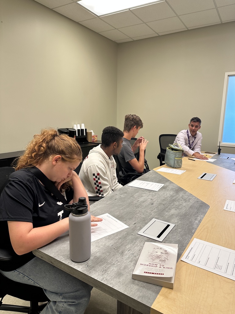 group of senior leaders sitting at a table for a meeting