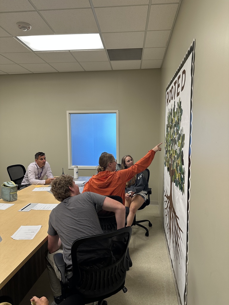 group of senior leaders sitting at a table for a meeting