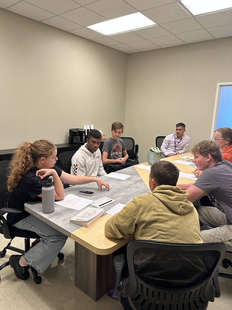group of senior leaders sitting at a table for a meeting