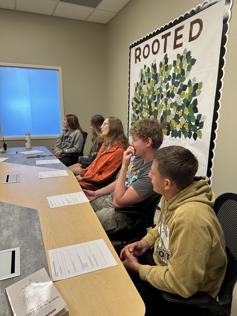 group of senior leaders sitting at a table for a meeting